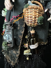Load image into Gallery viewer, Close detail of the Traveling Apothecary’s basket, lantern, and bottle