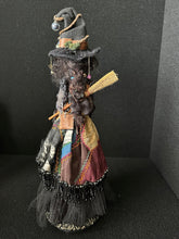 Load image into Gallery viewer, Back view showing the Traveling Apothecary’s patchwork clothing and broom