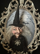 Load image into Gallery viewer, She Knows Who Comes After Dark in an ornate oval frame
