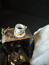 Load image into Gallery viewer, Miniature floral teacup resting atop Madame Tinker’s clockwork case