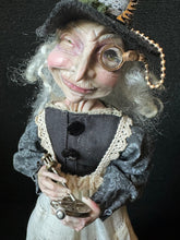 Load image into Gallery viewer, Close-up of Madame Tinker’s face, monocle, and clock mechanism