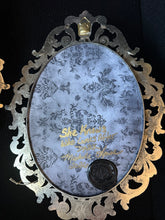 Load image into Gallery viewer, Signed and dated decorative backing of She Knows Who Comes After Dark