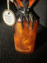Load image into Gallery viewer, Close view of BW5 shimmering orange potion and black wax