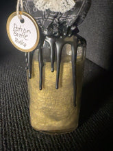 Load image into Gallery viewer, Close view of BW6 Edmund green-gold shimmering potion and black wax