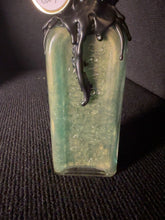 Load image into Gallery viewer, Green and gold shifting potion inside BW9 medicine bottle